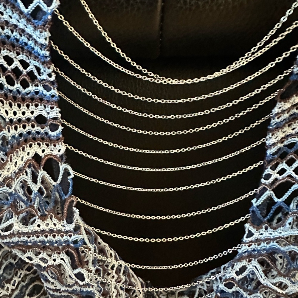 Alberto Malaki crochet swim cover with chain back design.